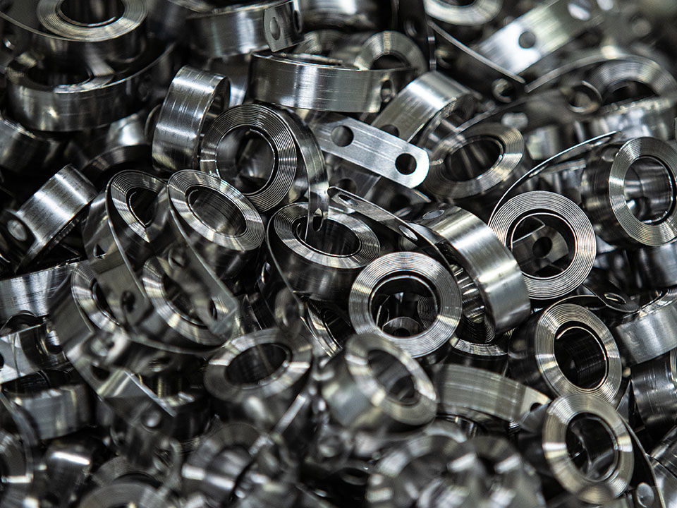 Production run of constant force springs illustrating contract spring manufacturing carried out by Automated Industrial Motion